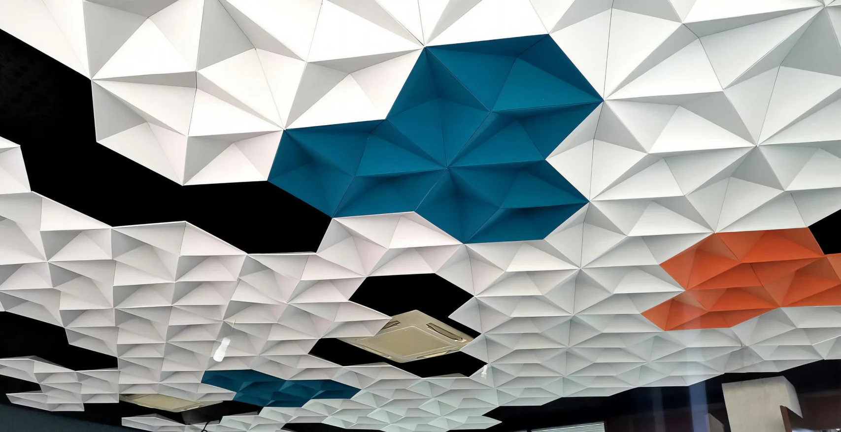 Supplier-provided visualization of white, blue, and orange faceted acoustic ceiling modules