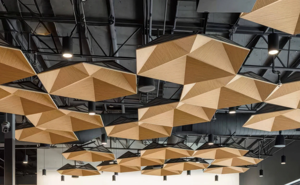 Supplier-provided visualization of tan polygonal acoustic clouds in a commercial interior