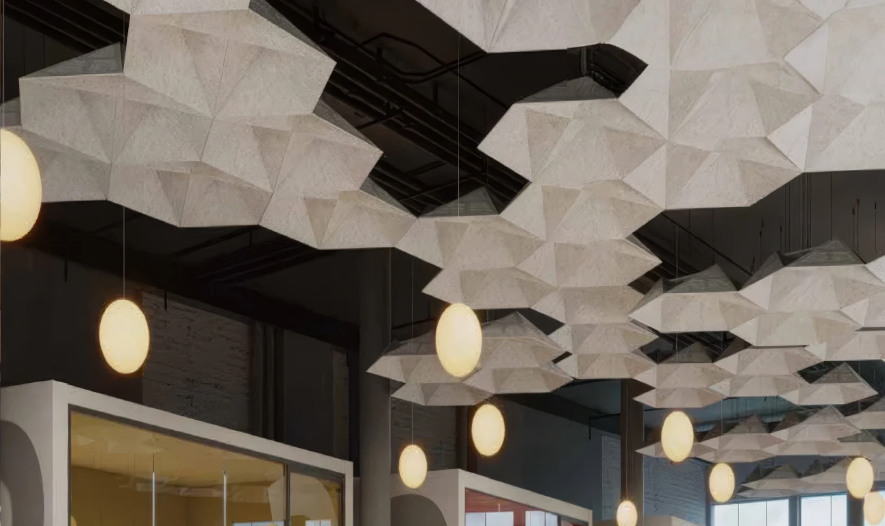 Supplier-provided visualization of white faceted acoustic ceiling modules around pendant lights