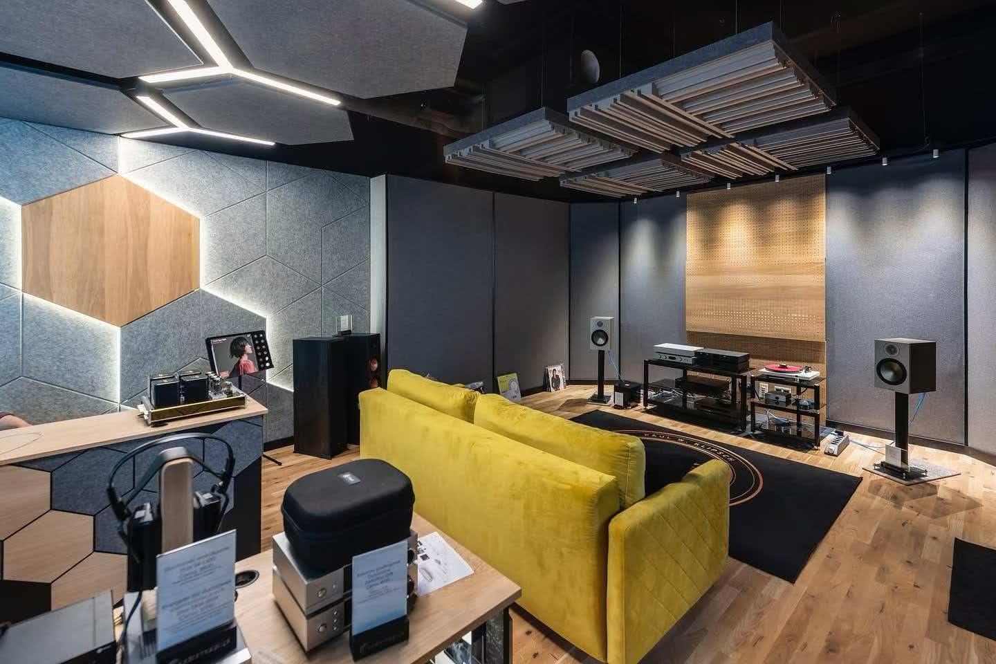 Listening room with geometric wall panels and suspended ceiling treatments